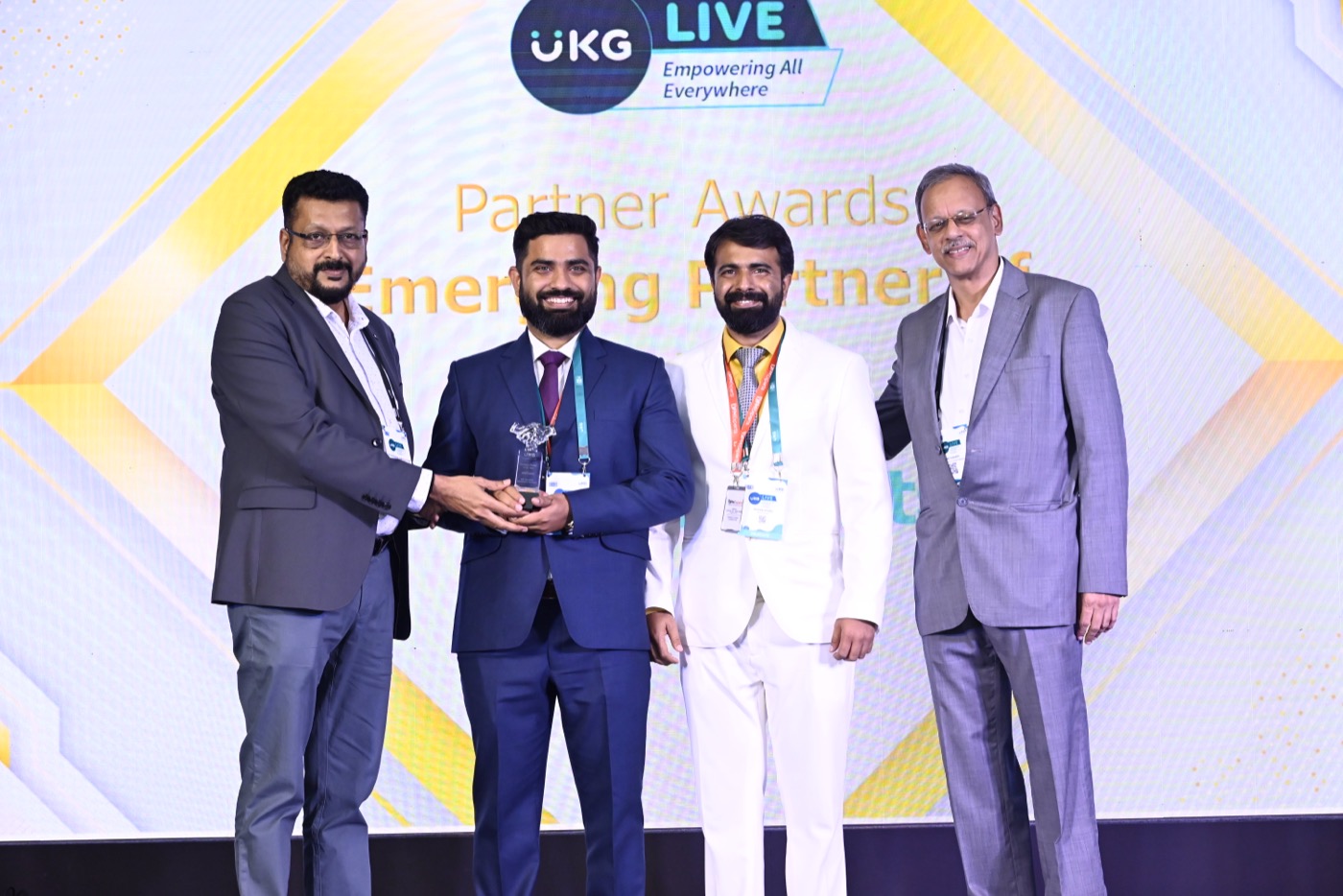 The WFM Experts leadership team receiving the Emerging Partner award on stage at the UKG Partner Awards